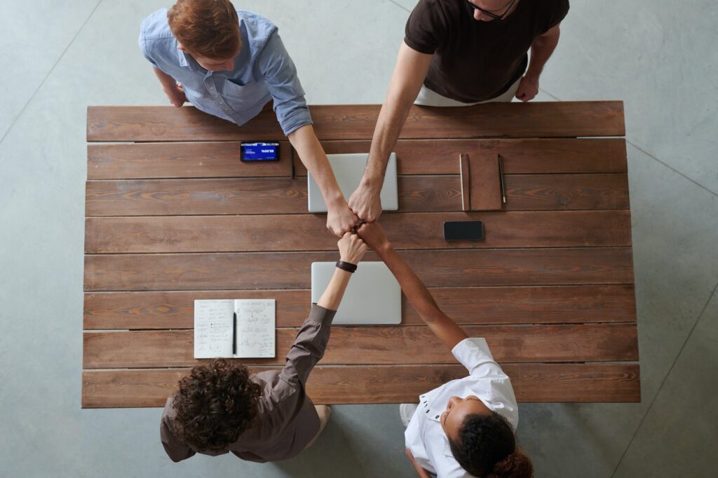 photo of people doing fist bump