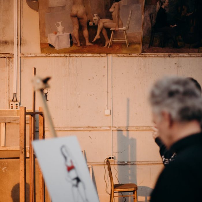 photo of a man painting a woman