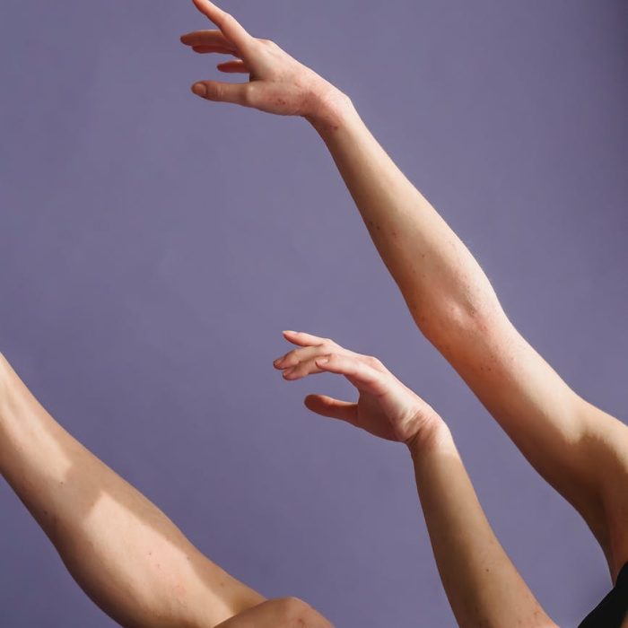 woman raising hands gracefully in studio